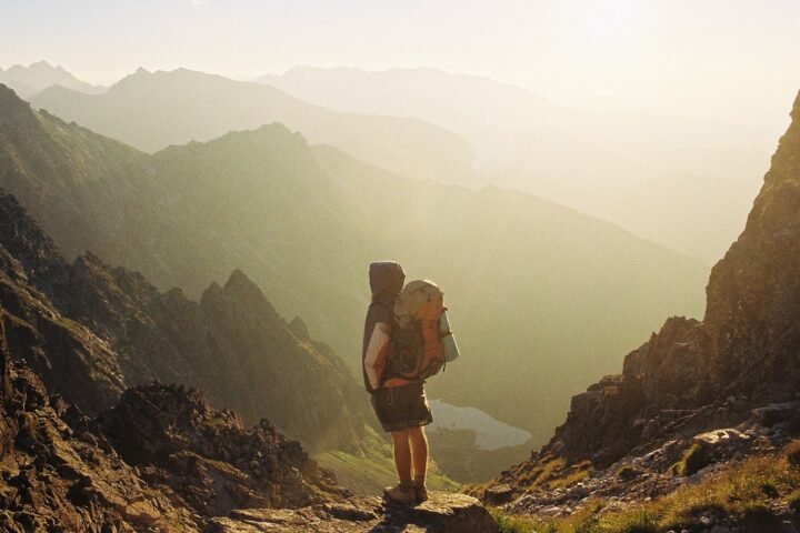 Hiker carrying a backpack in a mountain landscape