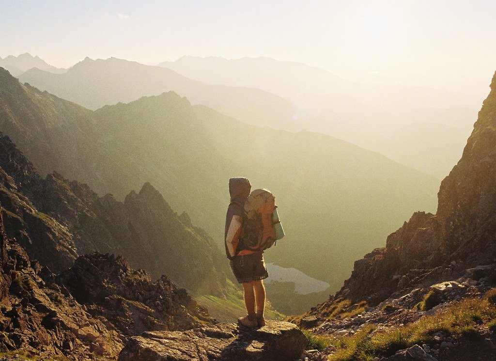 Hiker carrying a backpack in a mountain landscape
