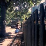 Walking down a street with luggage