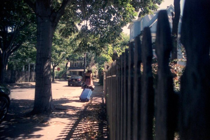 Walking down a street with luggage