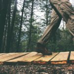 Person walking on wooden planks outdoors