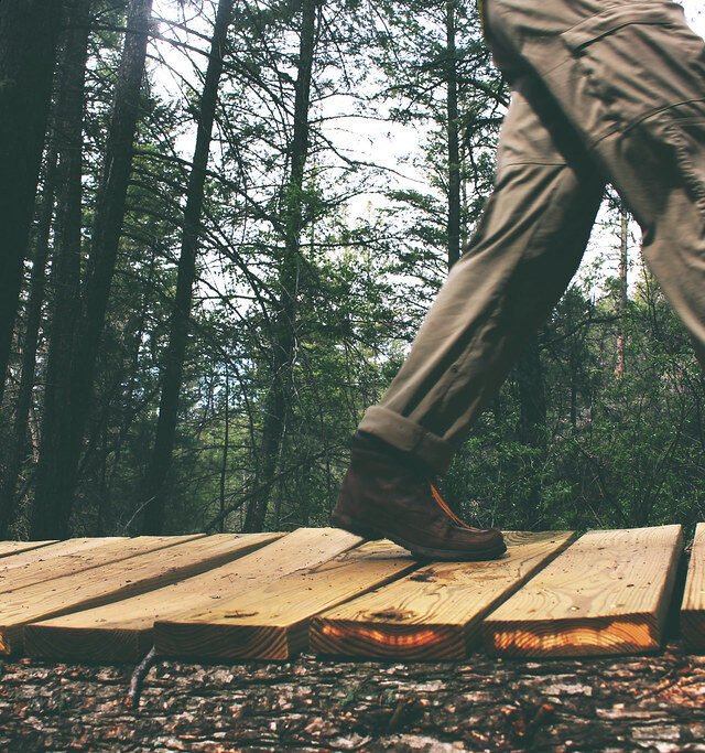 Person walking on wooden planks outdoors
