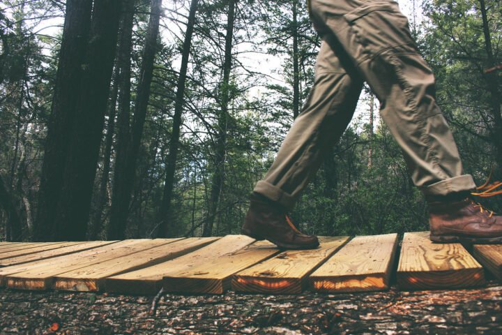 Person walking on wooden planks outdoors