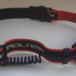LED headlamp with a head strap and a coiled cable