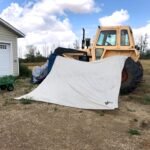 A tent hung over a tractor to dry