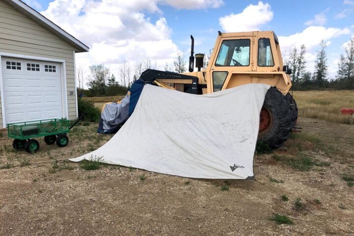 A tent hung over a tractor to dry