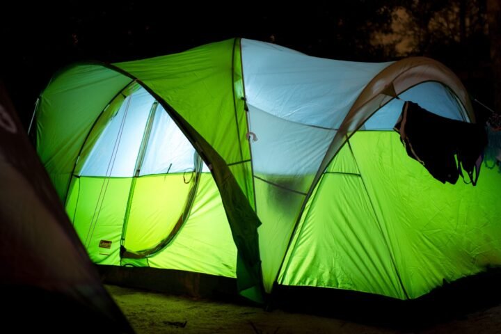 A camping tent illuminated at night
