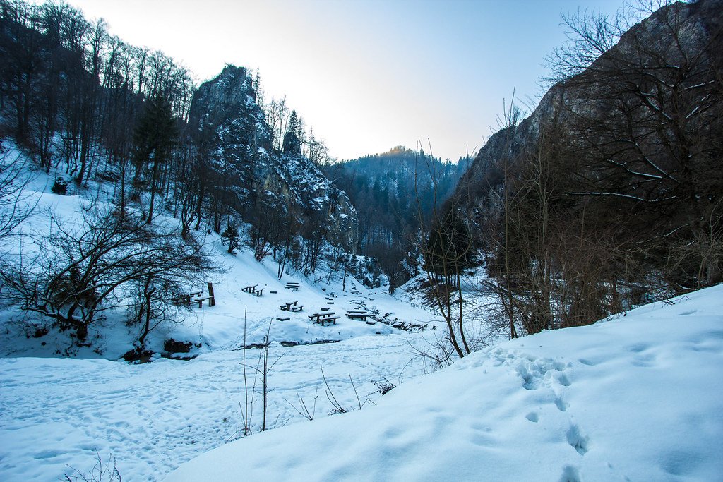 A mountain trail running through a valley in winter
