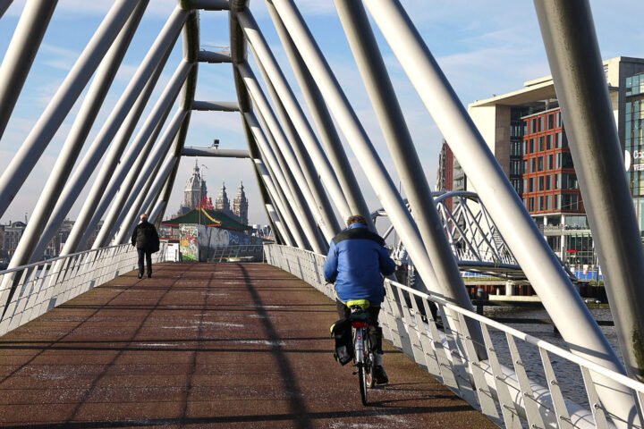 White metal tubes of the modern Oosterdok foot and bicycle bridge