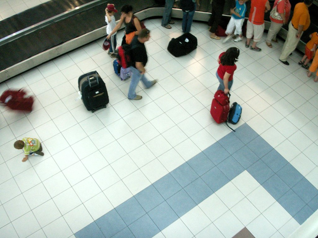 Waiting for luggage to arrive at an airport