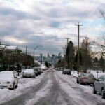 A snowy street in a city in winter