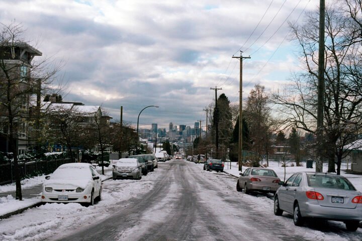 A snowy street in a city in winter