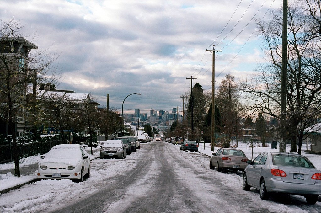 A snowy street in a city in winter